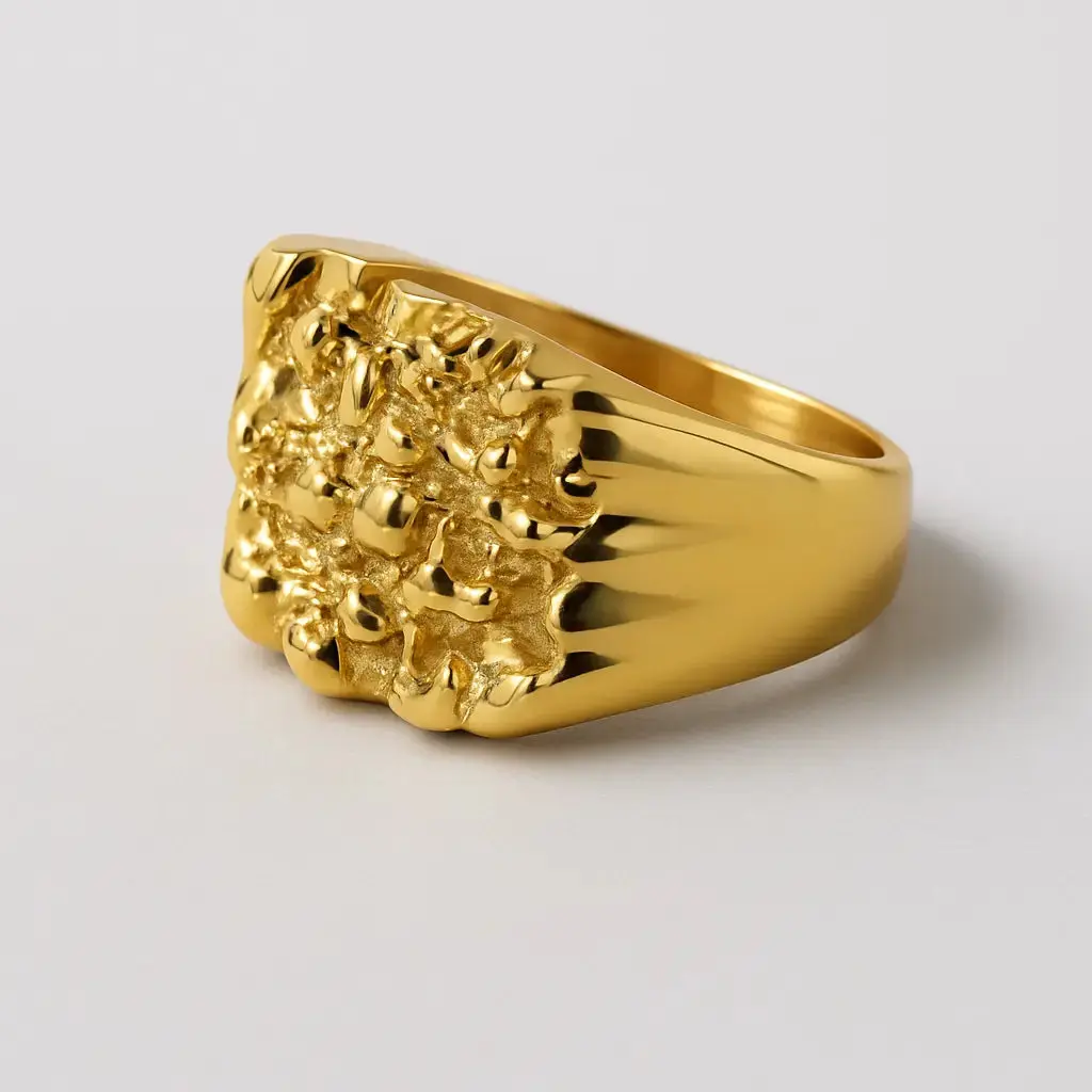 Gold  nugget ring with textured design on a light gray background